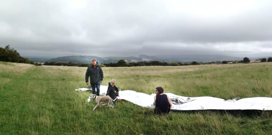 People drawing in a large field