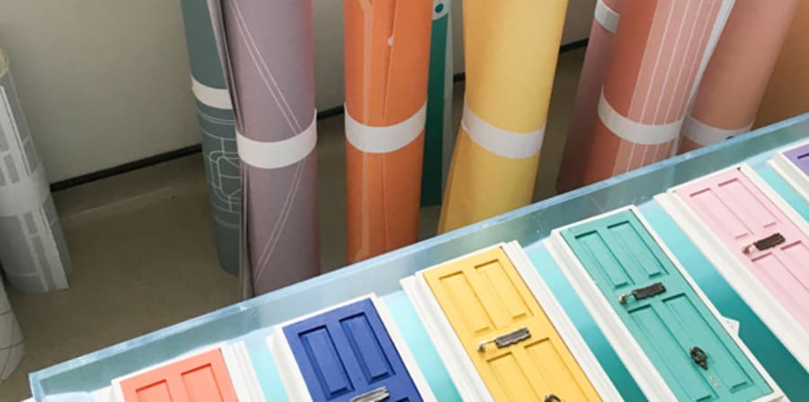 Colourful rolls of paper and photos of different colour front doors
