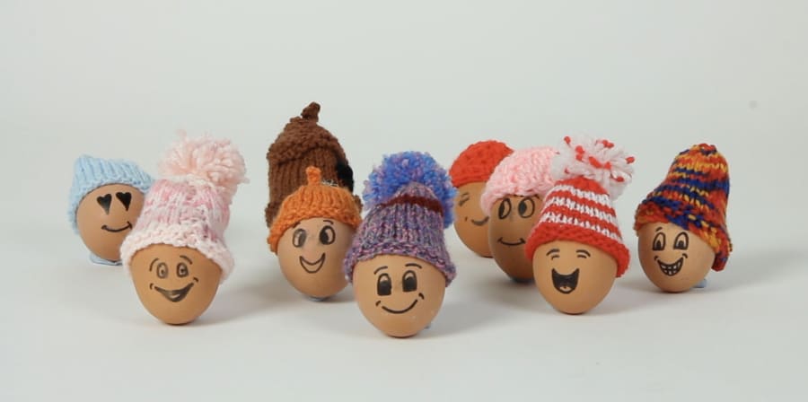 A still of eggs with smiles and bobble hats.