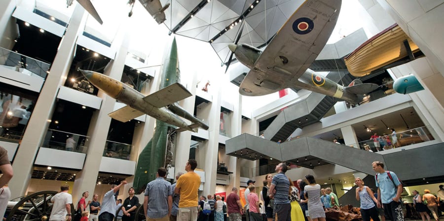A group of museum visitors explore an exhibition themed around the spitfire.