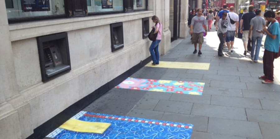 Colourful patterned paving stones around cash machines