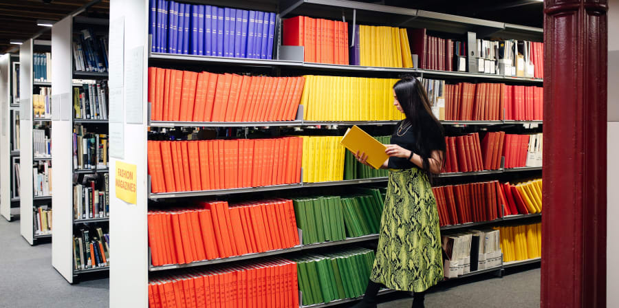 A student reading a book in the library 