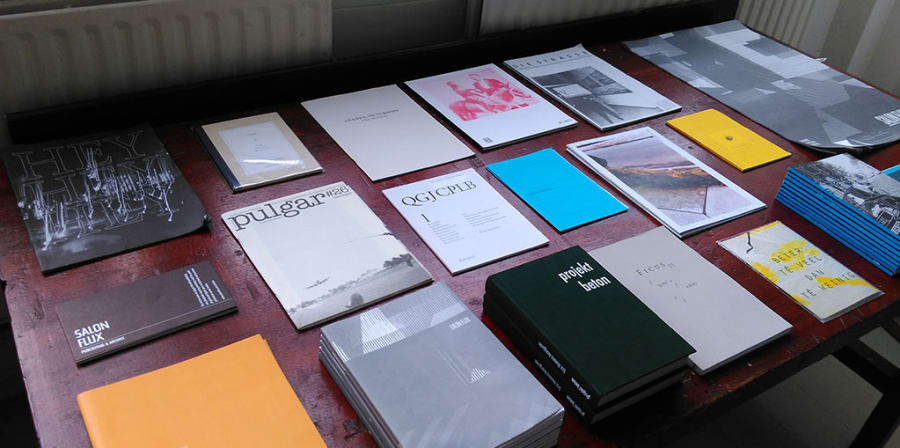 A table is filled with a range of independent arts publications.