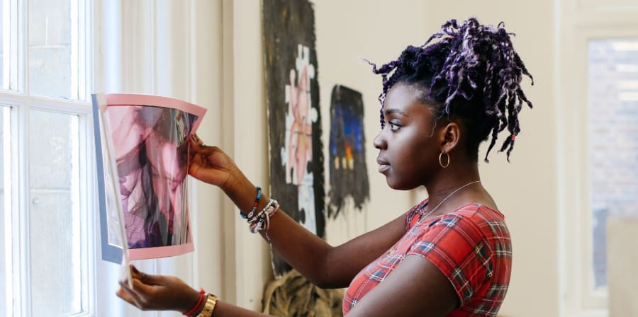 Student holding up artwork