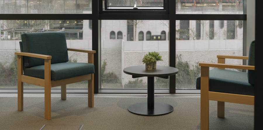 Two chairs against a window.