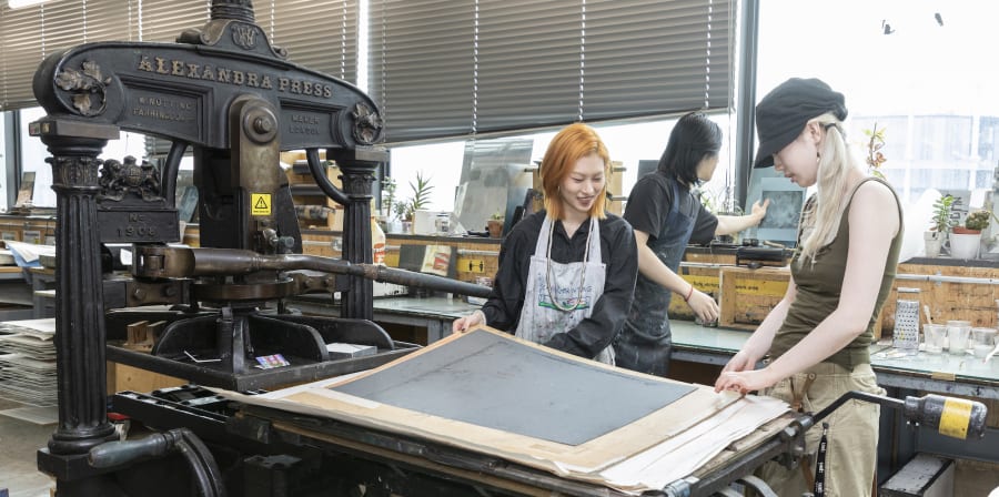 Students working at a printing press