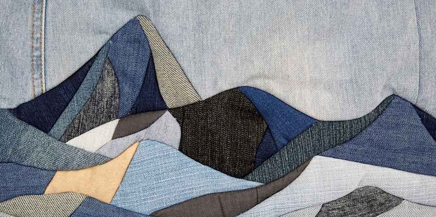 Denim patchwork illustration of a mountain landscape