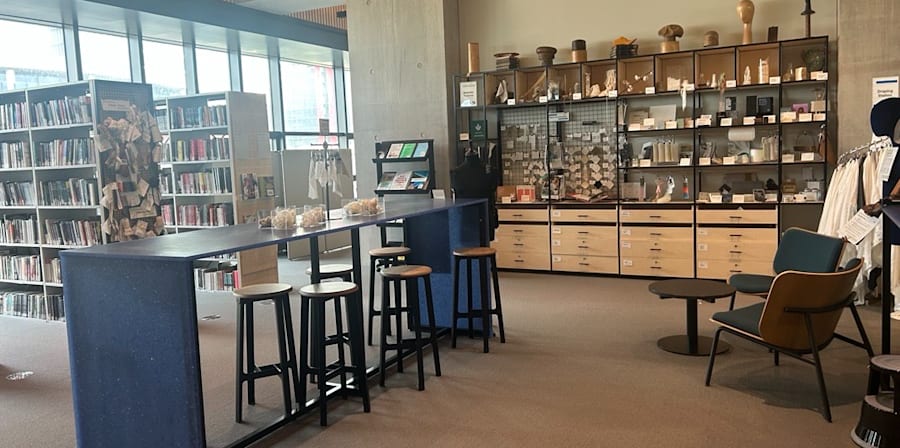 Tables, chairs and materials arranged in display cabinets in the Materials Area in LCF Library.