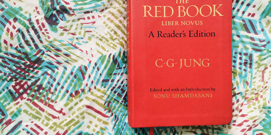 Image depicts The Red Book on a floral background.