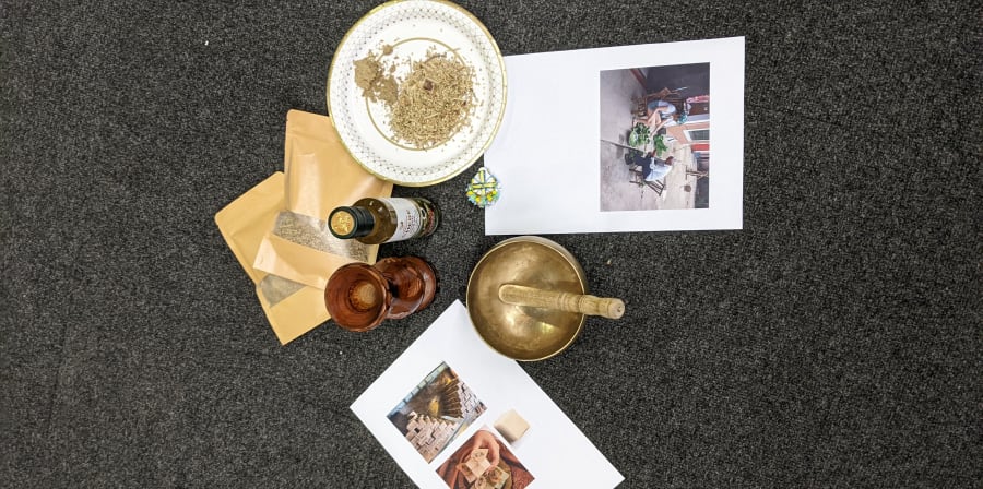 Objects from a workshop laid out on grey carpet.