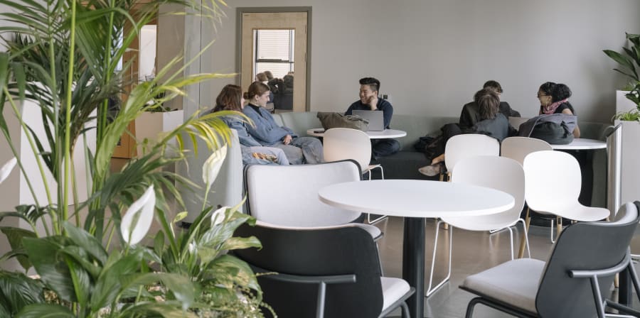 People sat around a white table talking and laughing.