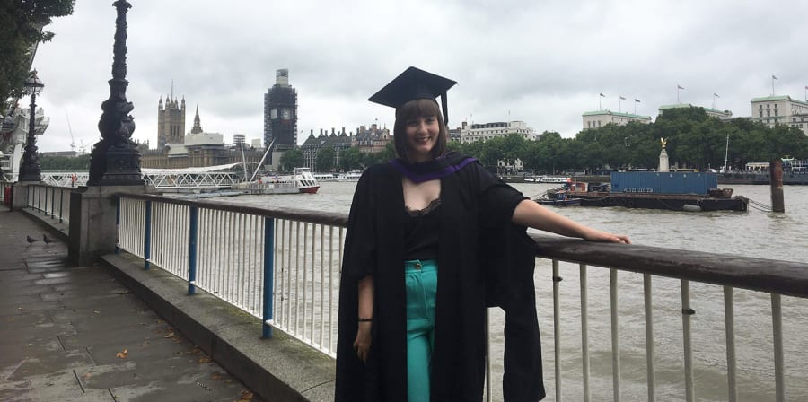Hannah stands on the South Bank after graduating from LCC.