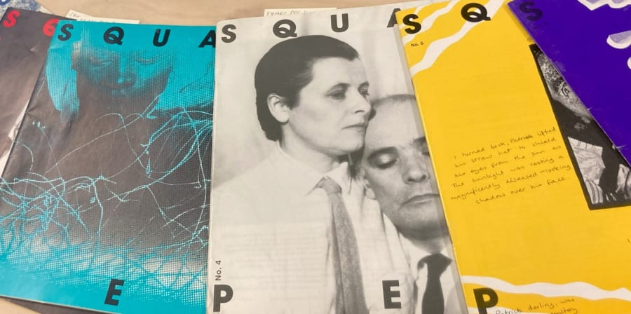 Colour photograph showing a spread of magazines titled Square Peg. The front of the magazines show a range of colourful cover artwork and photography. The cover artwork includes a black and white portrait of a person wearing a shirt and tie with slicked back hair embracing another person also wearing shirt and tie. Another magazine cover with a yellow background has a reproduction of a handwritten comment on it reading, ‘I turned back, Patrick lifted his straw hat to shield his eyes from the sun as the sunlight was casting a magnificently diseased-looking shadow over his face’.