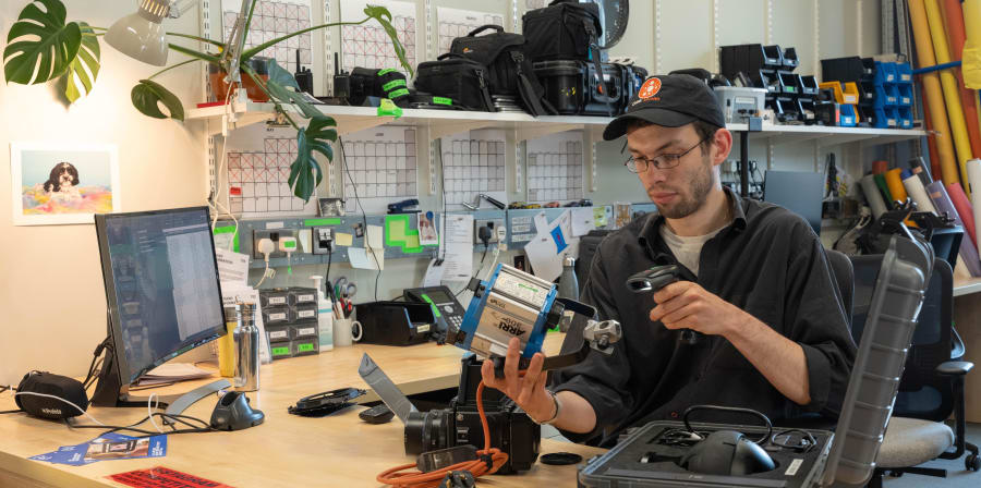 Person at a desk with camera equipment.
