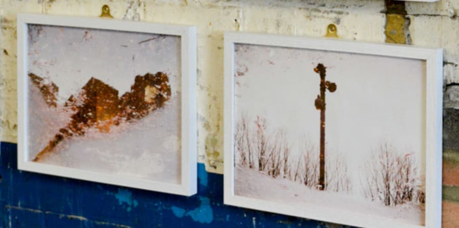 Framed sepia photgraphs mounted on a shabby-chic wall