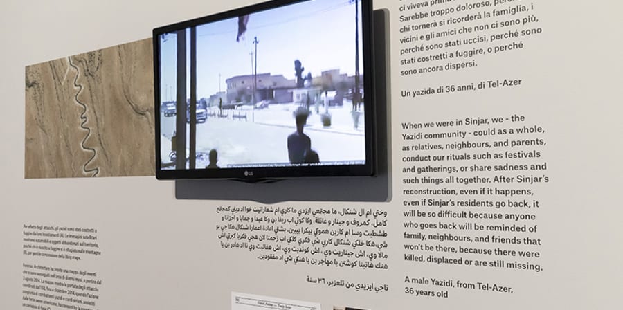 Photo of Maps of Defiance exhibition with screen and text about Sinjar.