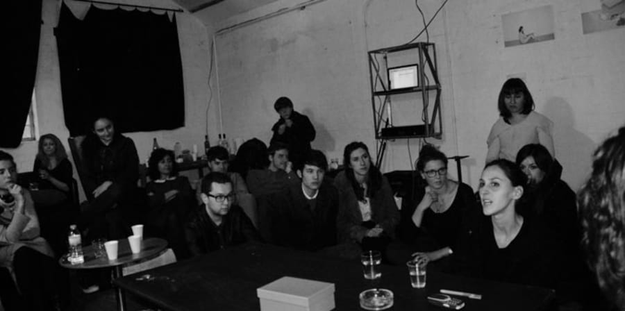 A black and white photograph depicting a discussion at a Salon Flux event.