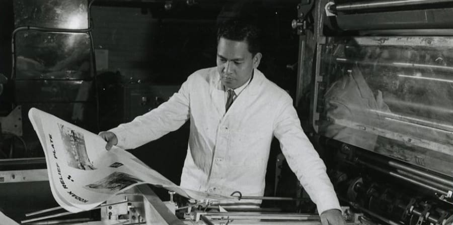 Black-and-white photograph of student at printing machine