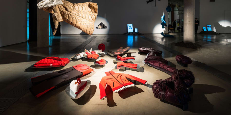 A shot of garments installed inside an exhibition space