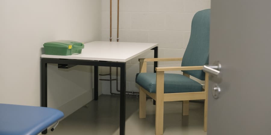 Room with medical box and chair.