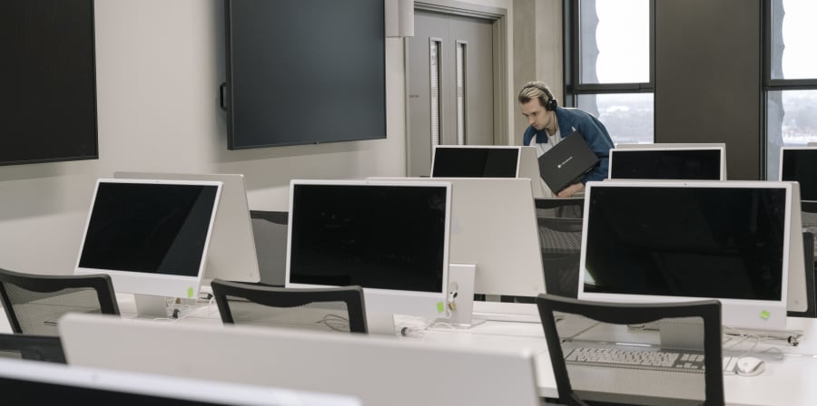 Rows of computers on desks.