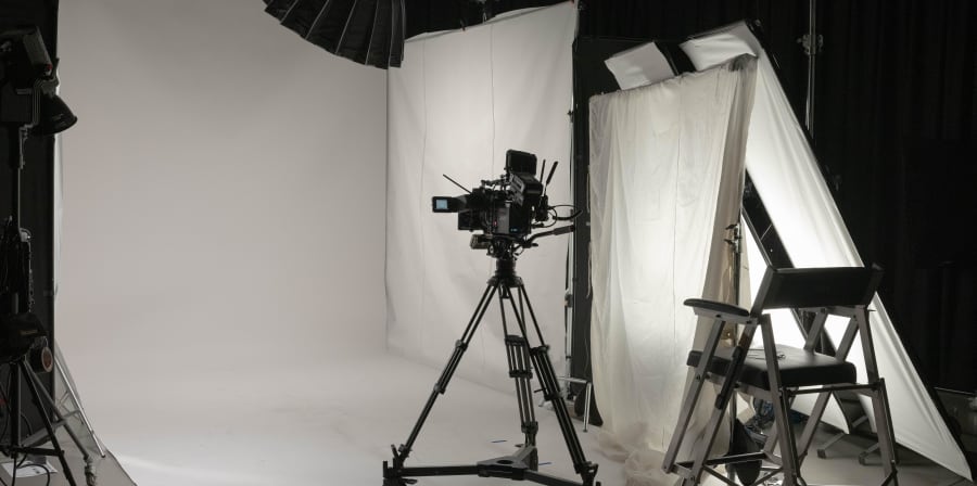 Studio with white curtains and camera in the middle.