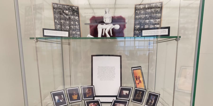 Display case showing archive objects and student work