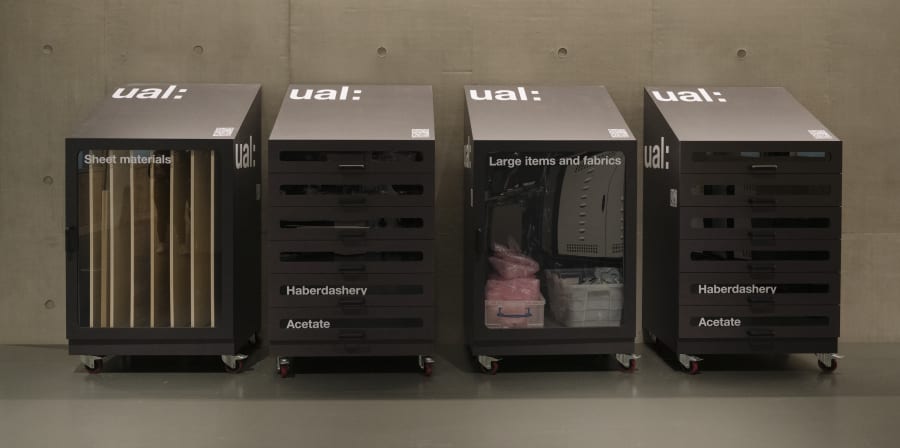 Four large trolley cupboards with fabrics and materials inside.
