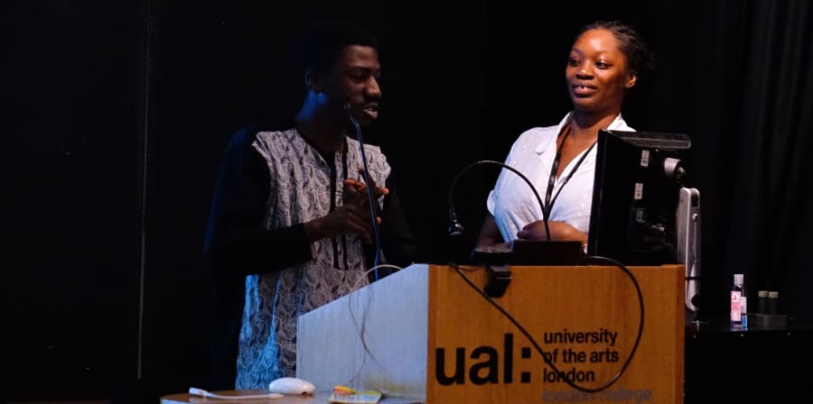 Mariama Wurie and another participant stand at the lectern