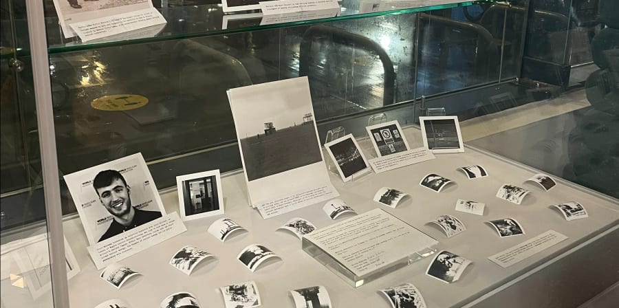 Display case showing archive objects and student work