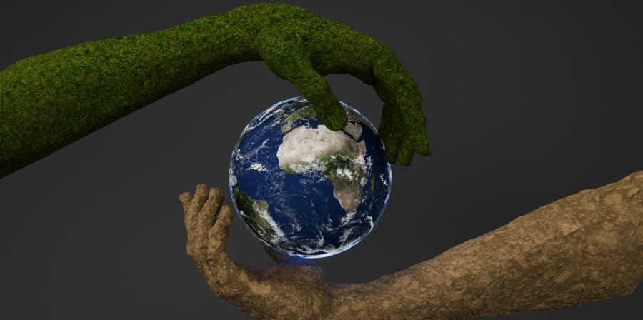 Arms made of grass and sand holding the earth.