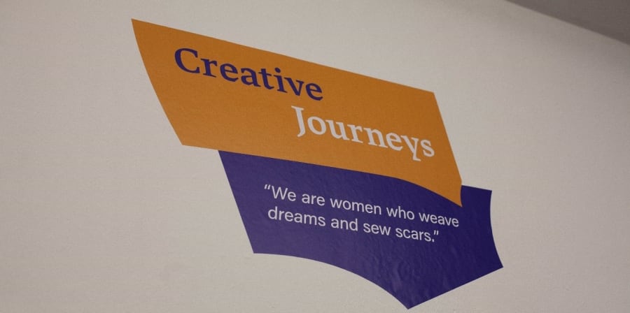 orange and purple logo  with text 'Creative Journeys'