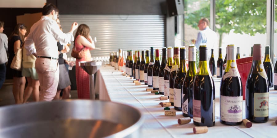 A long line of different wines lined up on a long table