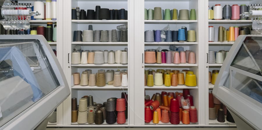 Shelves with colourful yarn on them.