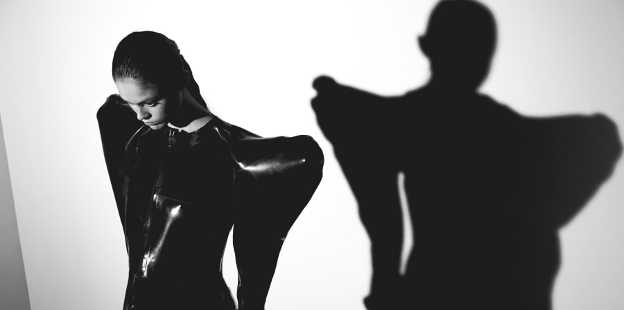 Models in black latex.