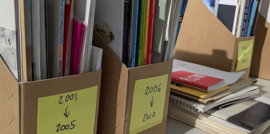 Items from the Camberwell Archive in boxes with post-it notes on them