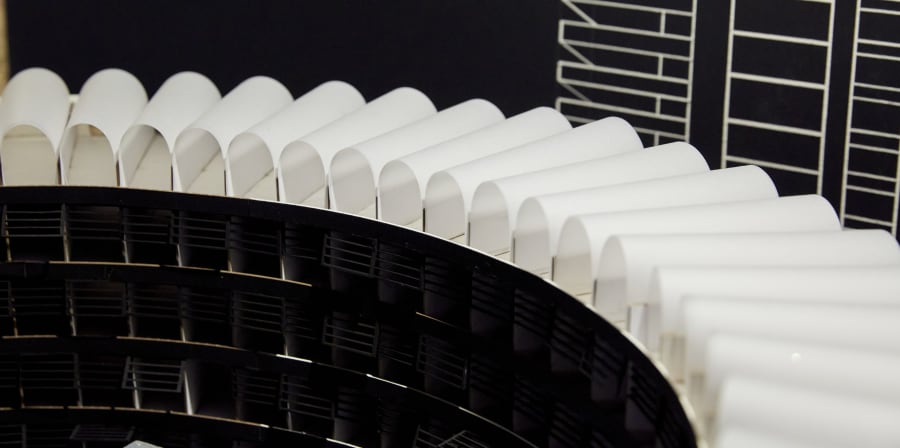 A model set of a building, the roof has curved paper-like ridges