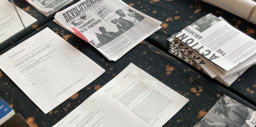 Photograph of lots of open books laid out on a table