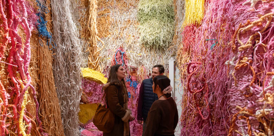 3 guests in room covered in colourful rope.