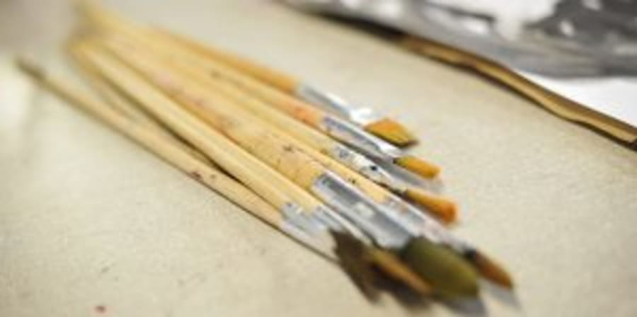 Image of paintbrushes on a worktop