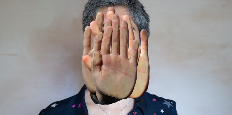Photograph of a woman with hands collaged over her face