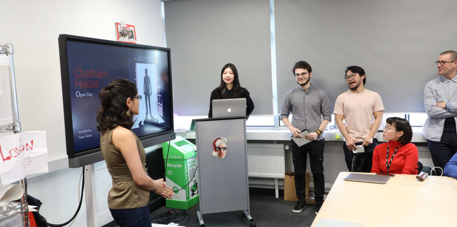Photo of UX Design students presenting design proposals.