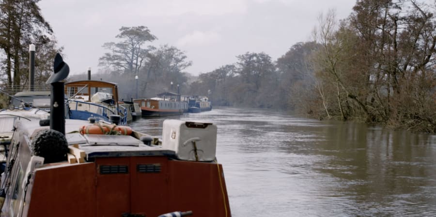 Still of a boat on a serene canal.