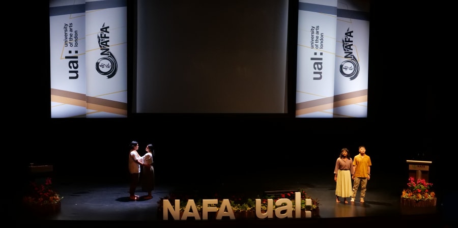 Performers on stage at ceremony, with UAL and NAFA logos in the background