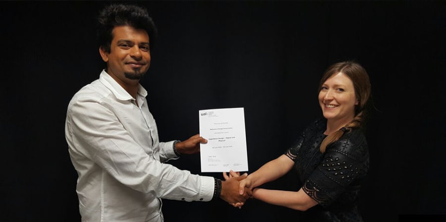 Photo of UAL certificate being presented