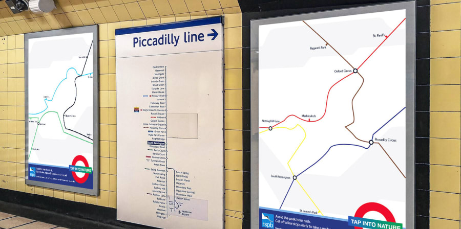 Tube maps shaped like birds are mocked up in an Underground Station.
