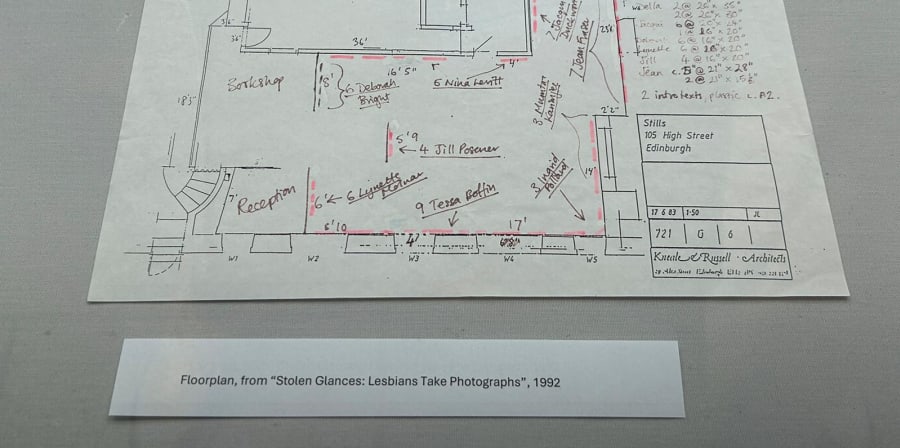 Colour photograph of an exhibition display case with colourful photographs