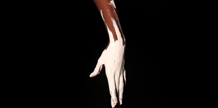 Black hand covered in white paint