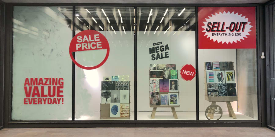 window gallery showing sell out signs in style of a shop