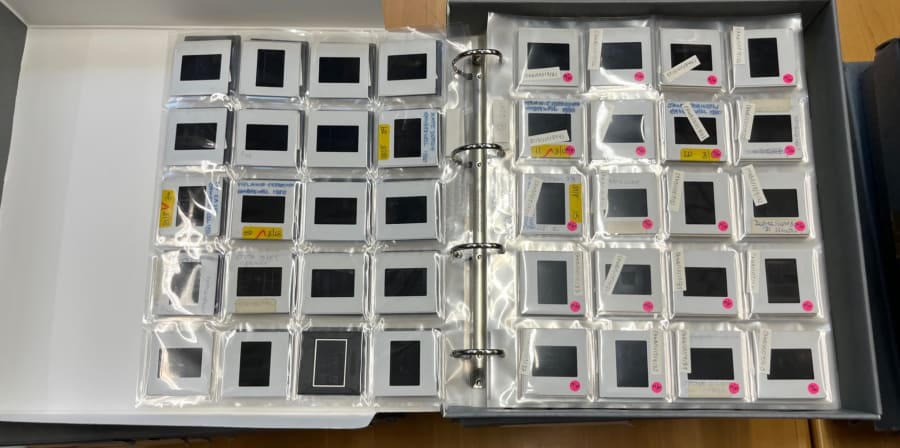 Colour photograph showing some 35mm slides in an archival folder